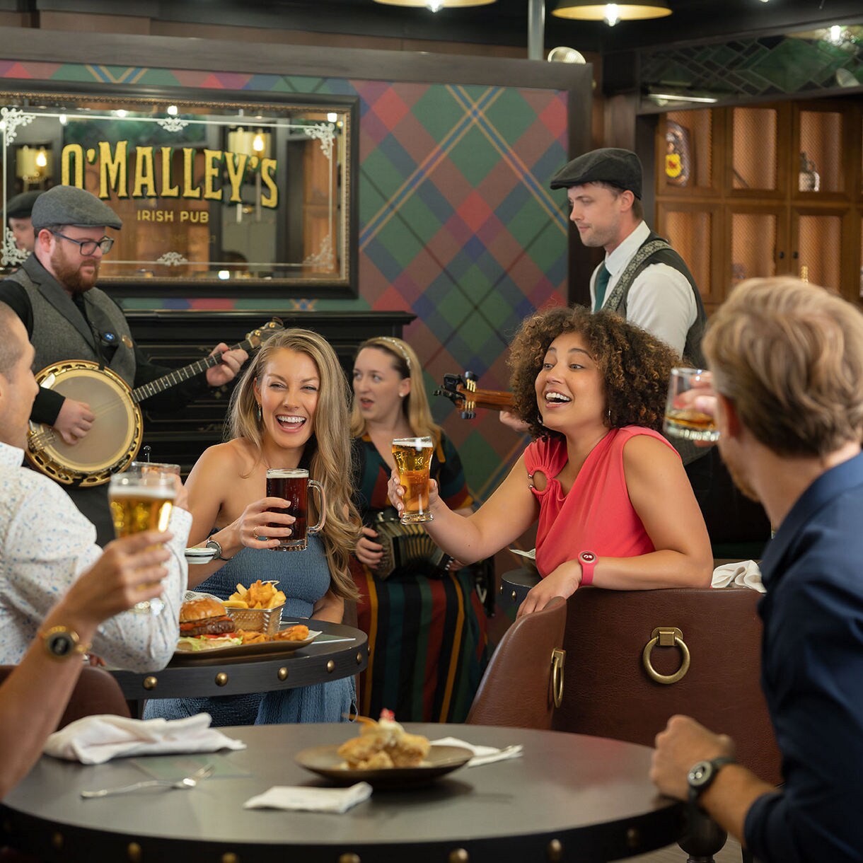 Group of people drinking and chatting at O'Malley's Irish Pub