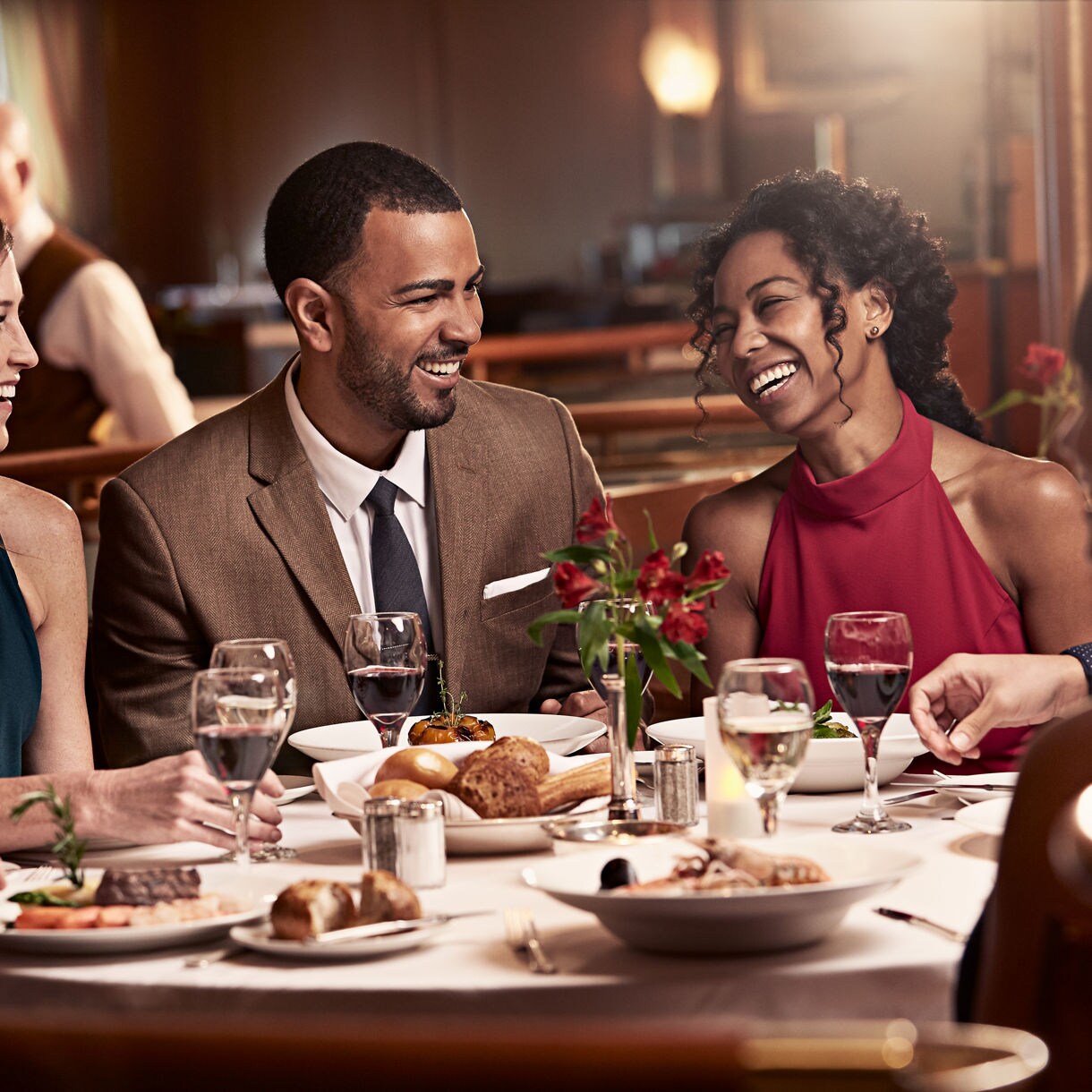 Guests having dinner and laughing