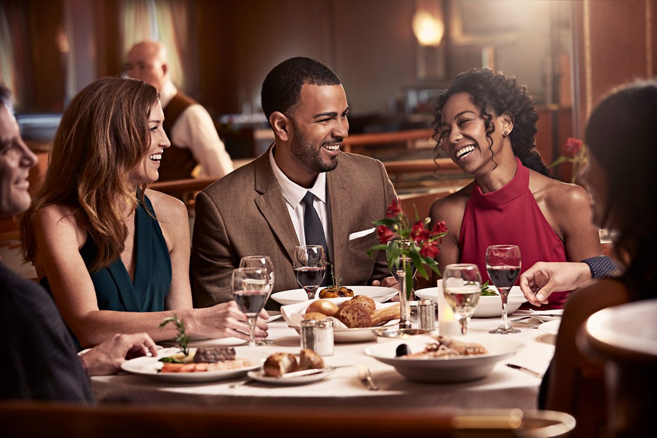 Guests having dinner and laughing