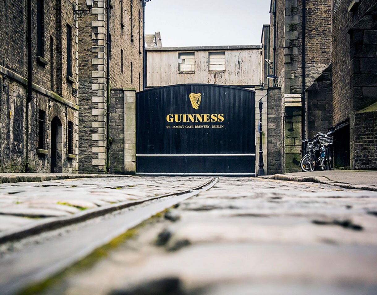 Cobblestone street leading to the black Guinness gate at St. James’s Gate Brewery in Dublin.