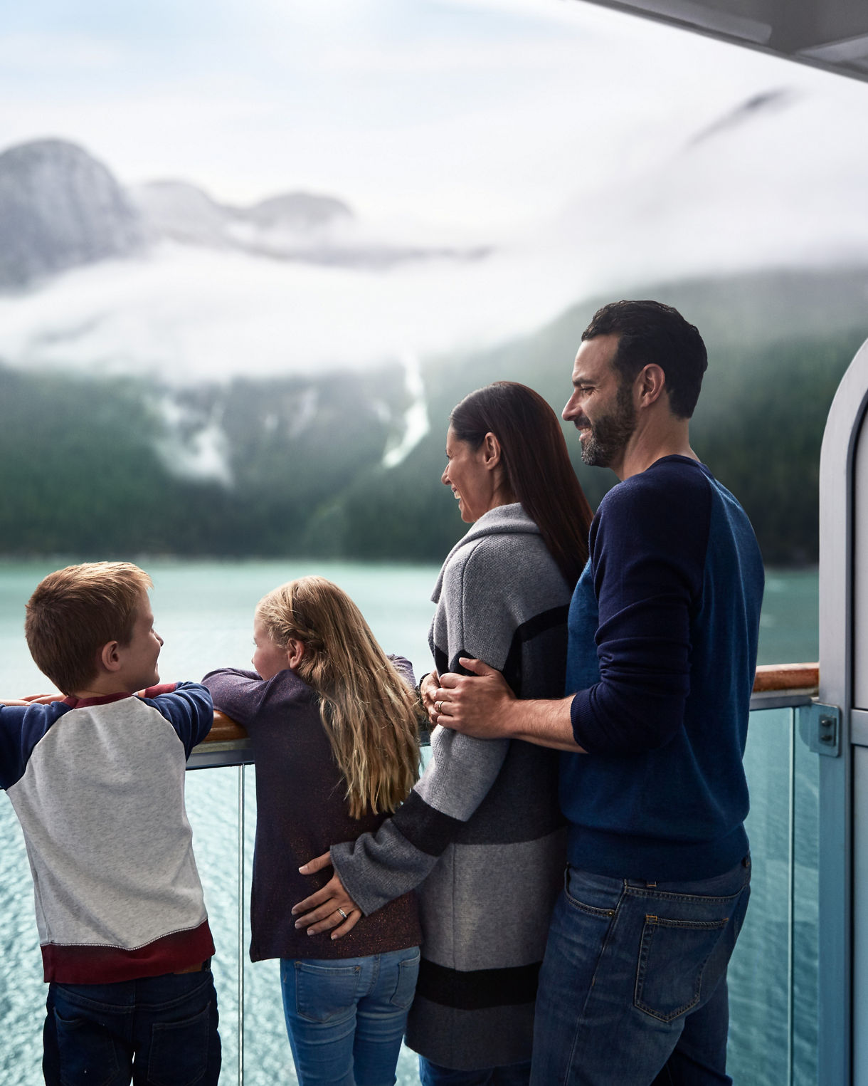 family viewing scenery from stateroom balcony