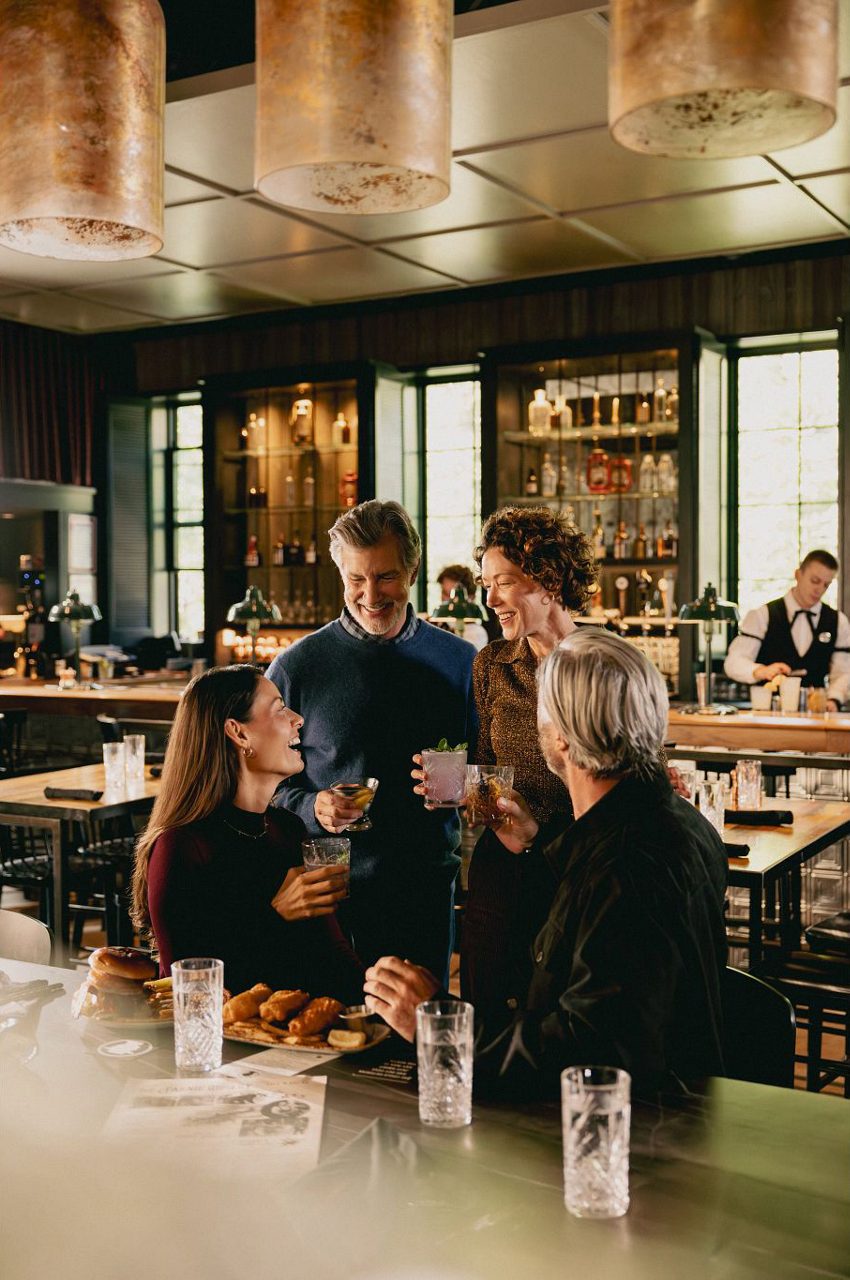 Beef wellington with colorful vegetable medley and green puree.
