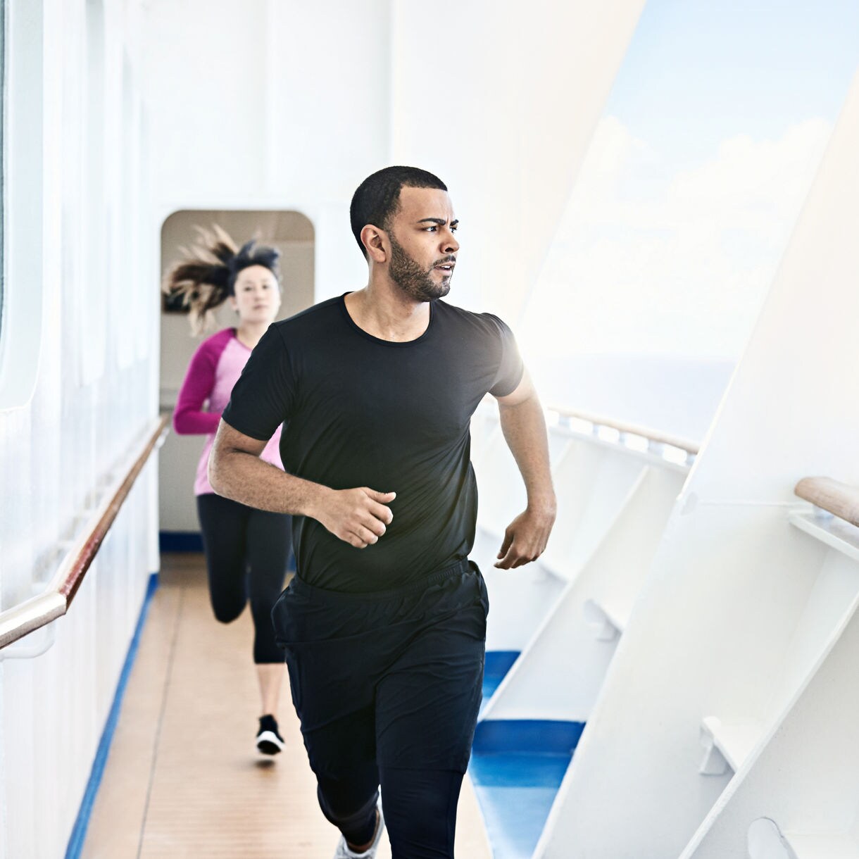 fitness couple jogging running on ship track