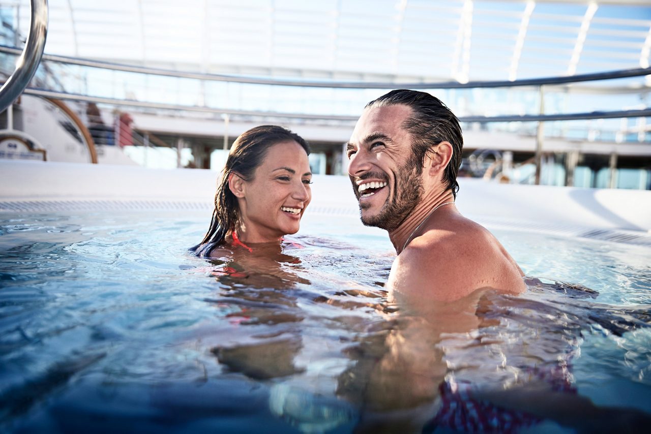 couple smiling in the hot tub pool