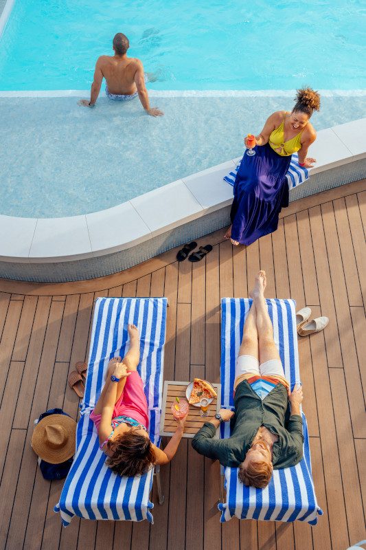 Guests enjoying drinks in outdoor seating area.