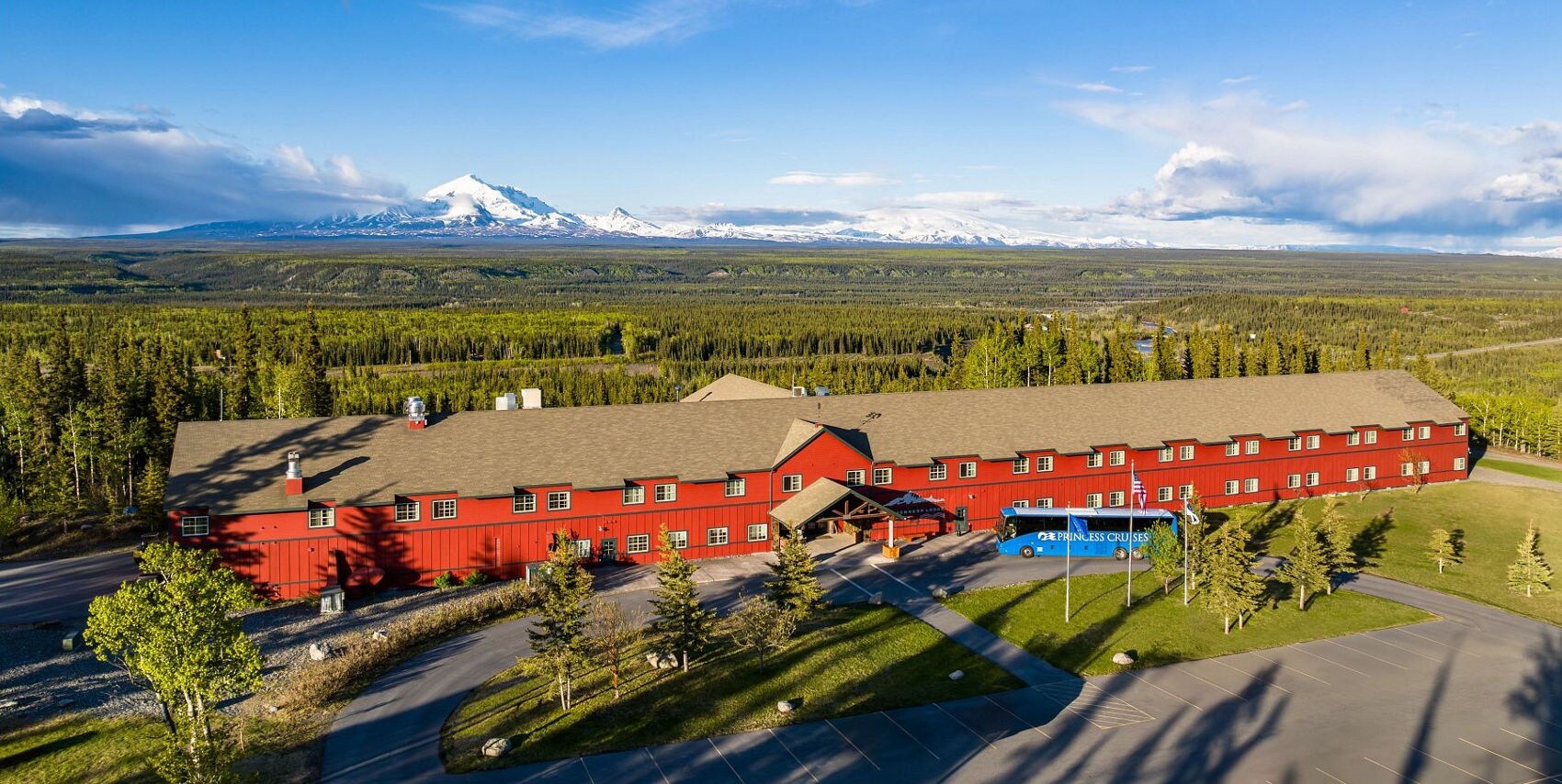 A couple walking on the grounds of Copper River Princess Wilderness Lodge.