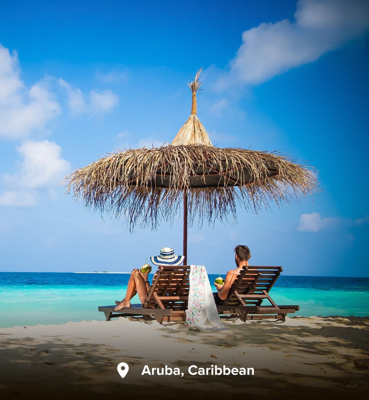 Couple under a parasol on a Caribbean beach