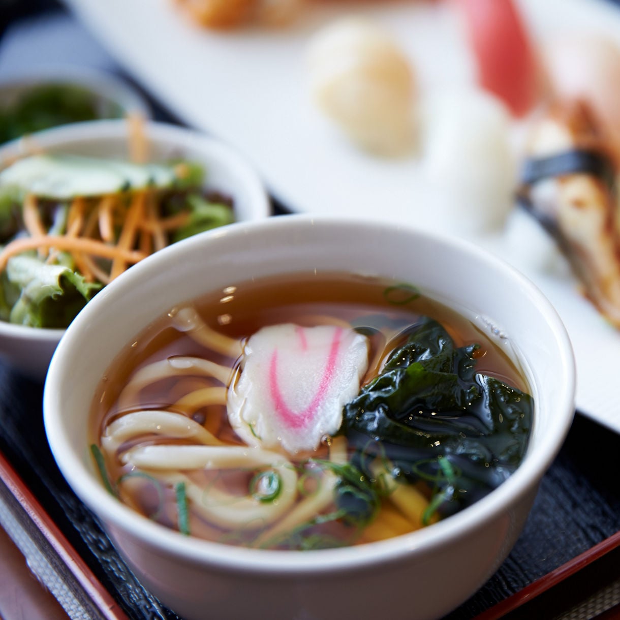 Udon noodle soup and sushi presented elegantly at Kai Sushi.