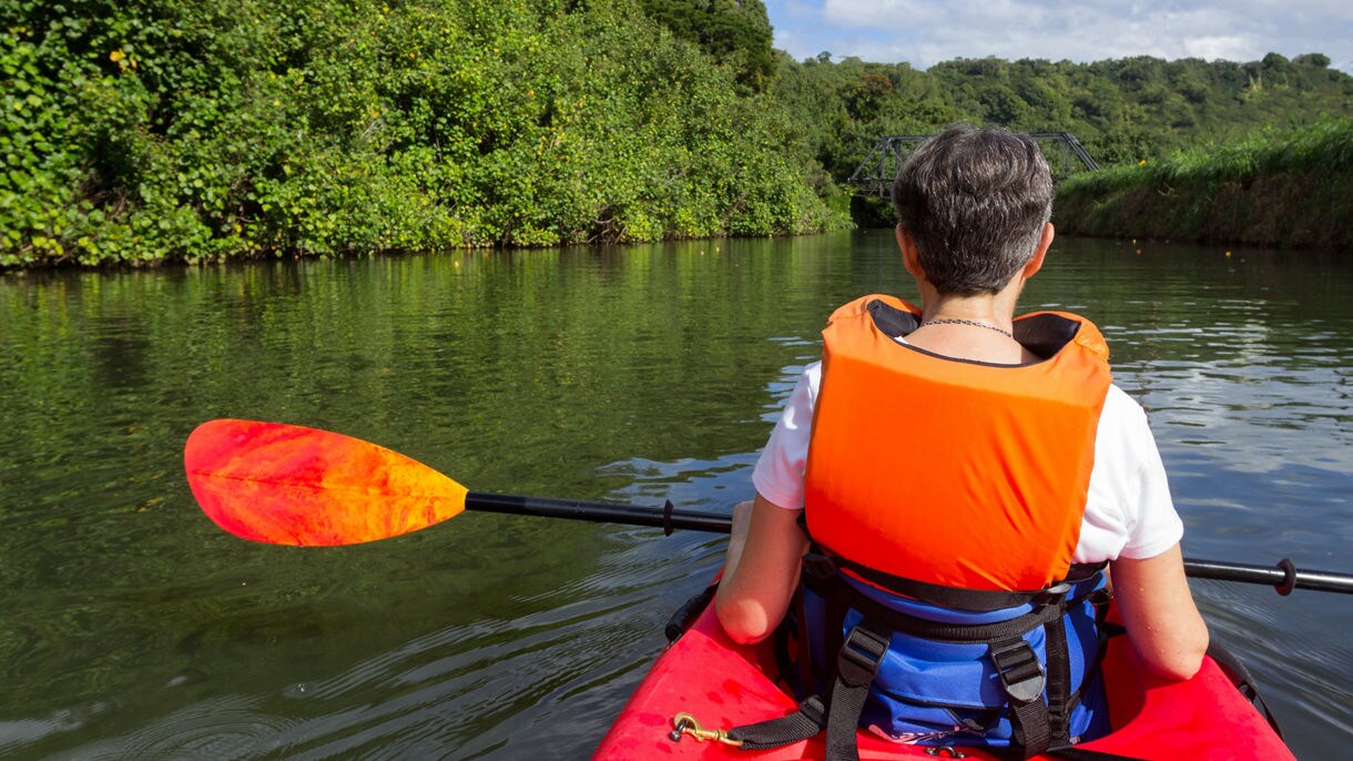 Retired caucasian lady in a red canoe or sea kayak on Hanalei river approaching the old steel bridge in Kauai; Shutterstock ID 176842523; Purchase Order: SDD Reminder #4 email, for Patricia; Job: Unlimited Seats, Unlimited Print Run, Unlimited Web & Worldwide Distribution; Client/Licensee: Princess Cruises; Other: ordered by Ward