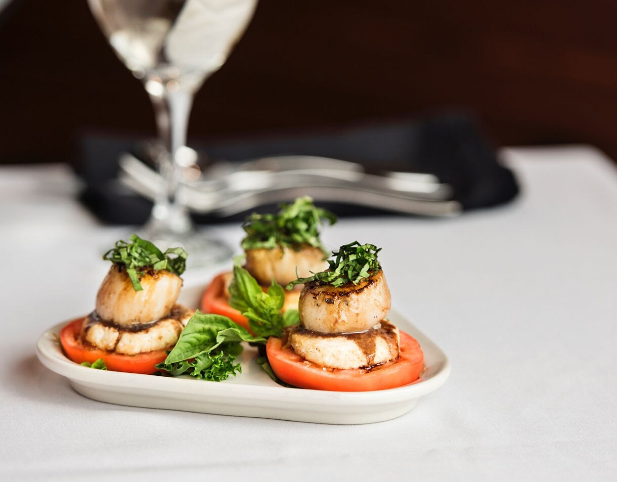 Seared Scallop Caprese with fresh tomato, basil, and a balsamic drizzle.