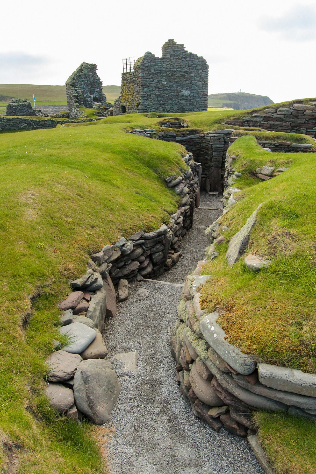 Aerial view of Playa de Las Teresitas in Tenerife with golden sand, turquoise water and lush green mountains rising behind the beach.