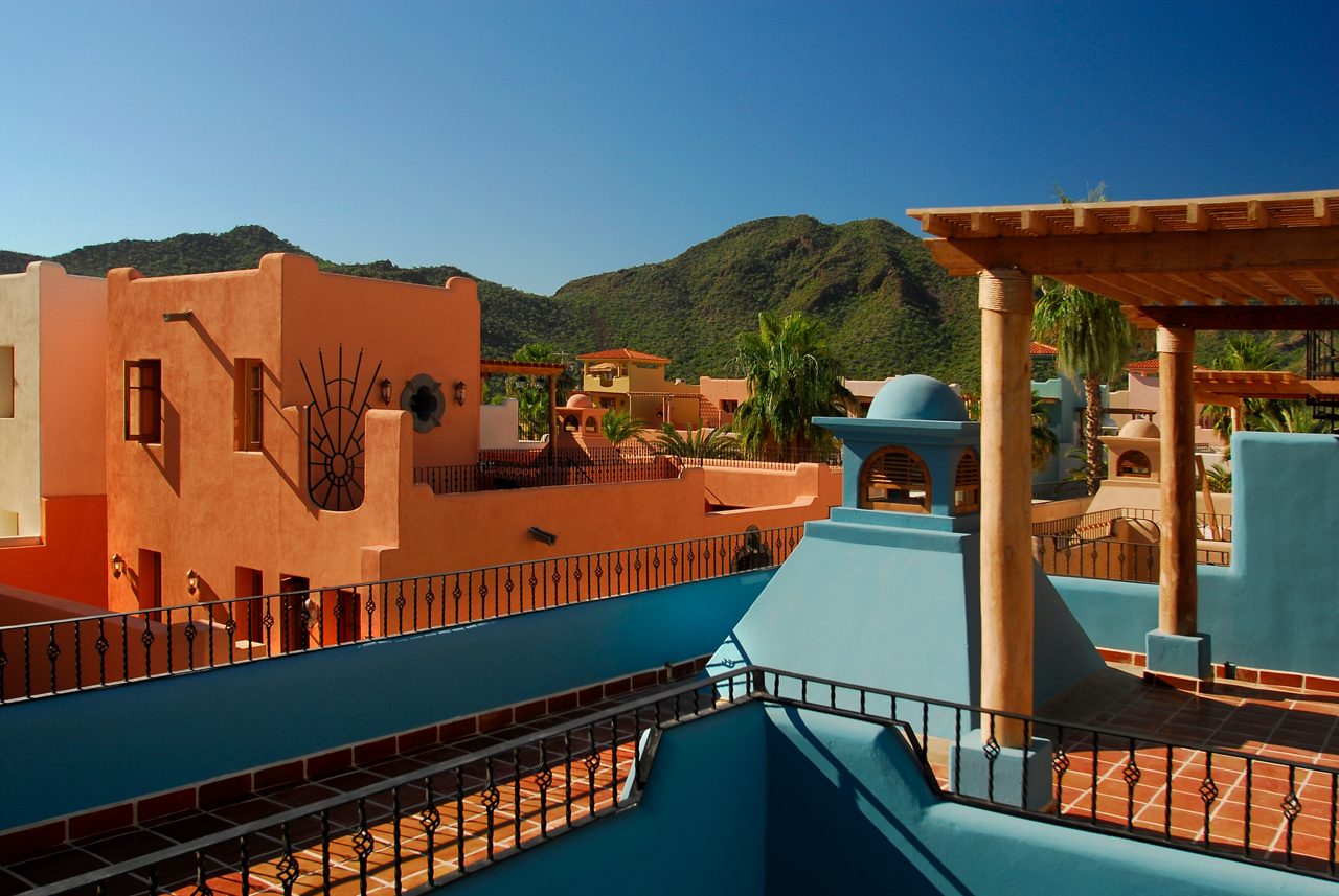 Colourful houses in front of green hills, Loreto, Mexico.