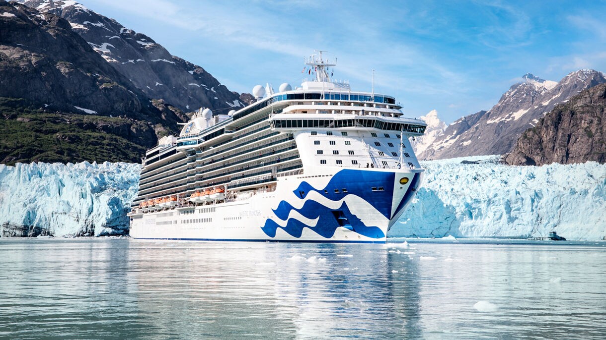 Princess cruise ship with large glaciers behind it