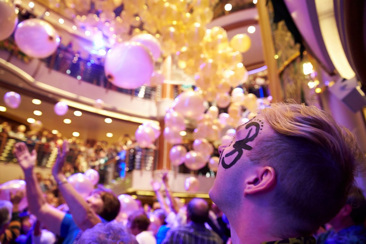 Balloons being dropped over celebrating crowd onboard.