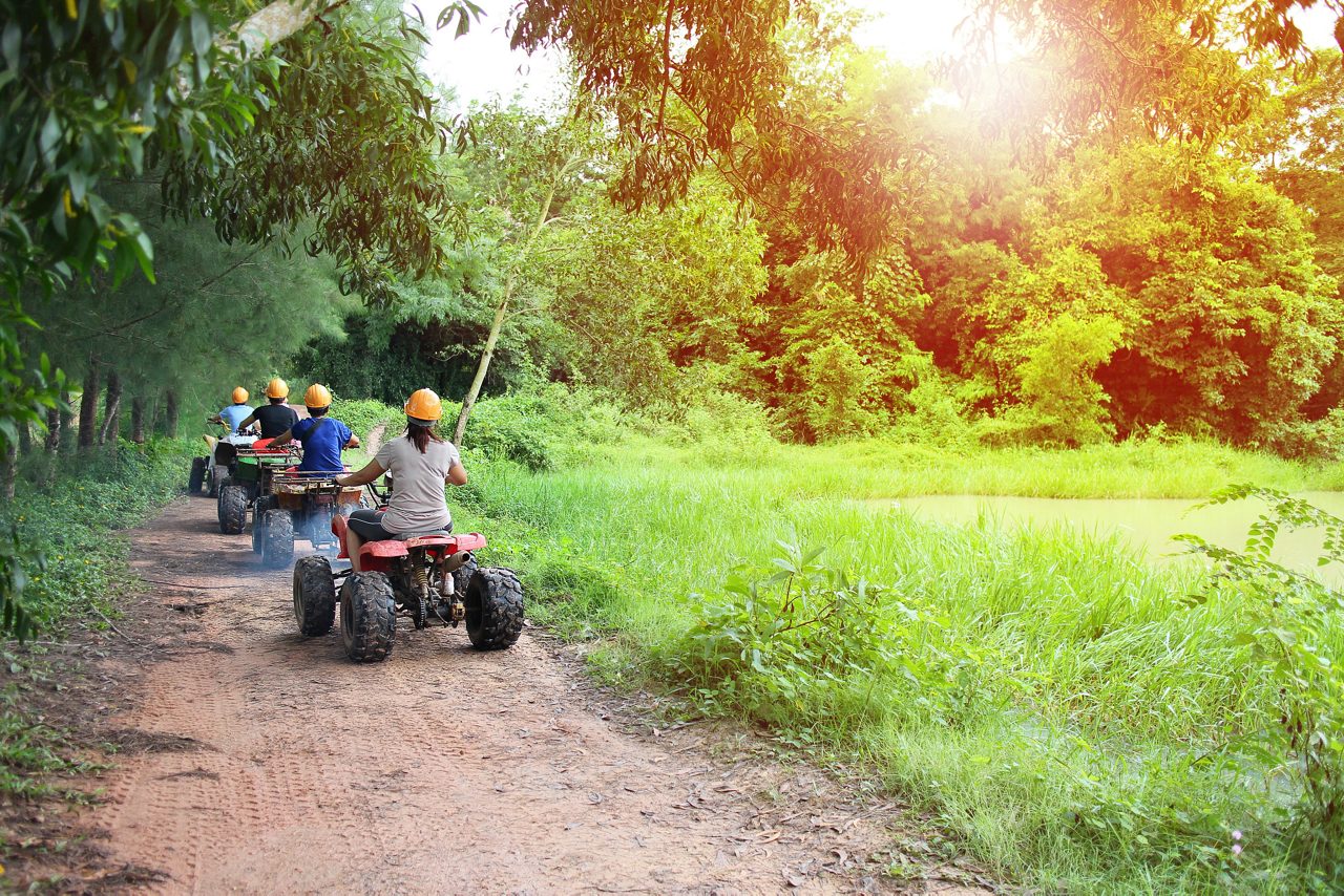 People riding ATV in Mexico jungle.