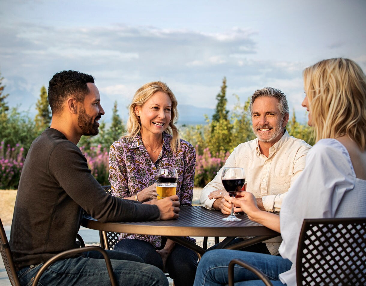 Gathering together at the Copper River Princess Wilderness Lodge's Whistle Stop Bar & Grill. Experiencing the perfect blend of good company and stunning views