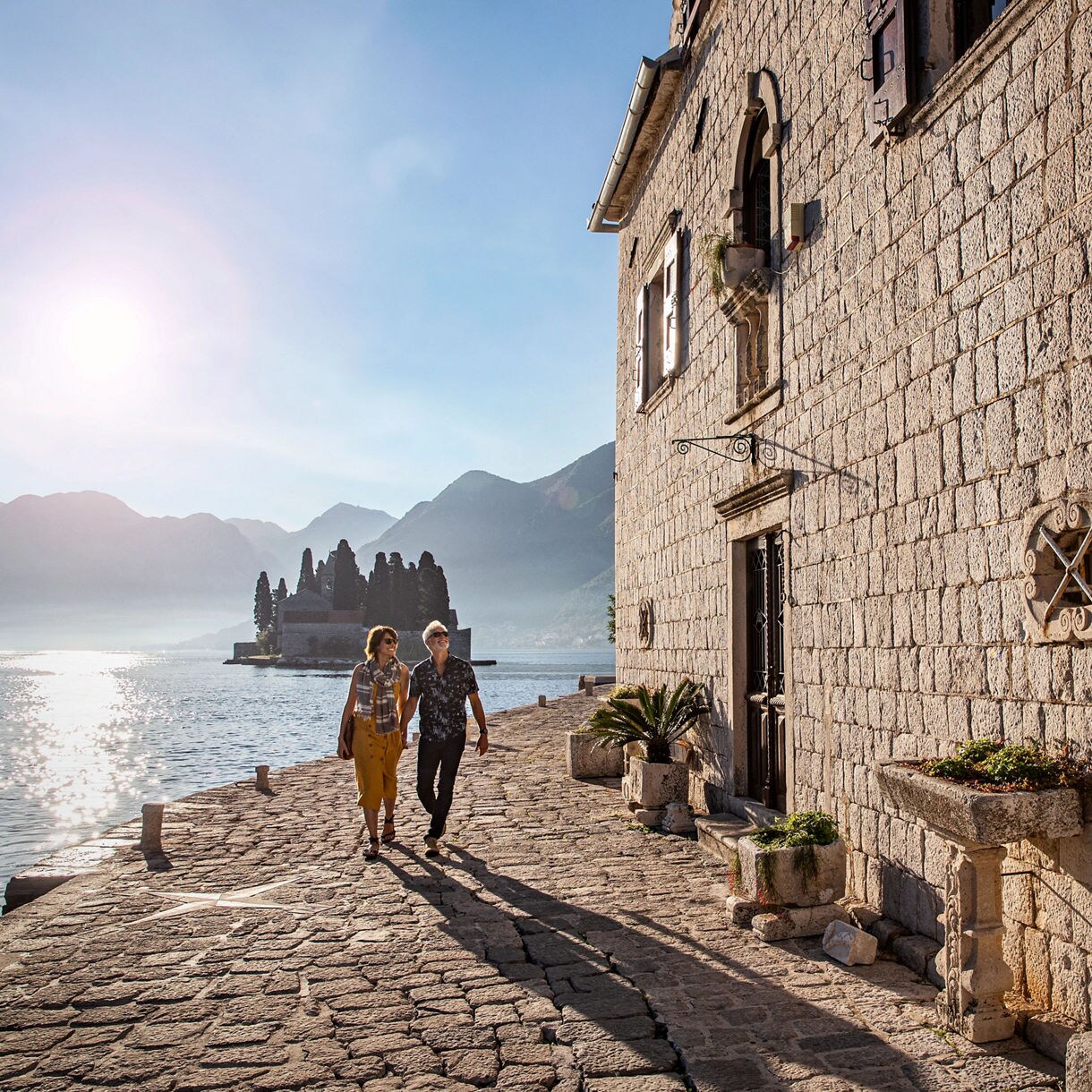 montenegro couple walking ocean cobblestone