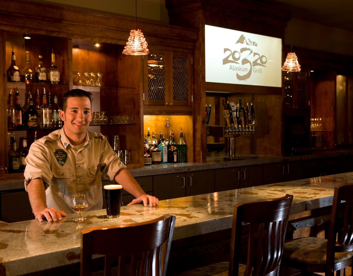 The 20,320 Alaskan Grill features a cozy lodge‑style bar with a full selection of Alaska craft beers and cocktails.