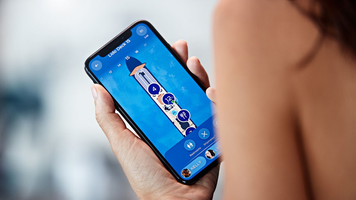 Couple using one of the screens onboard to navigate on the ship.