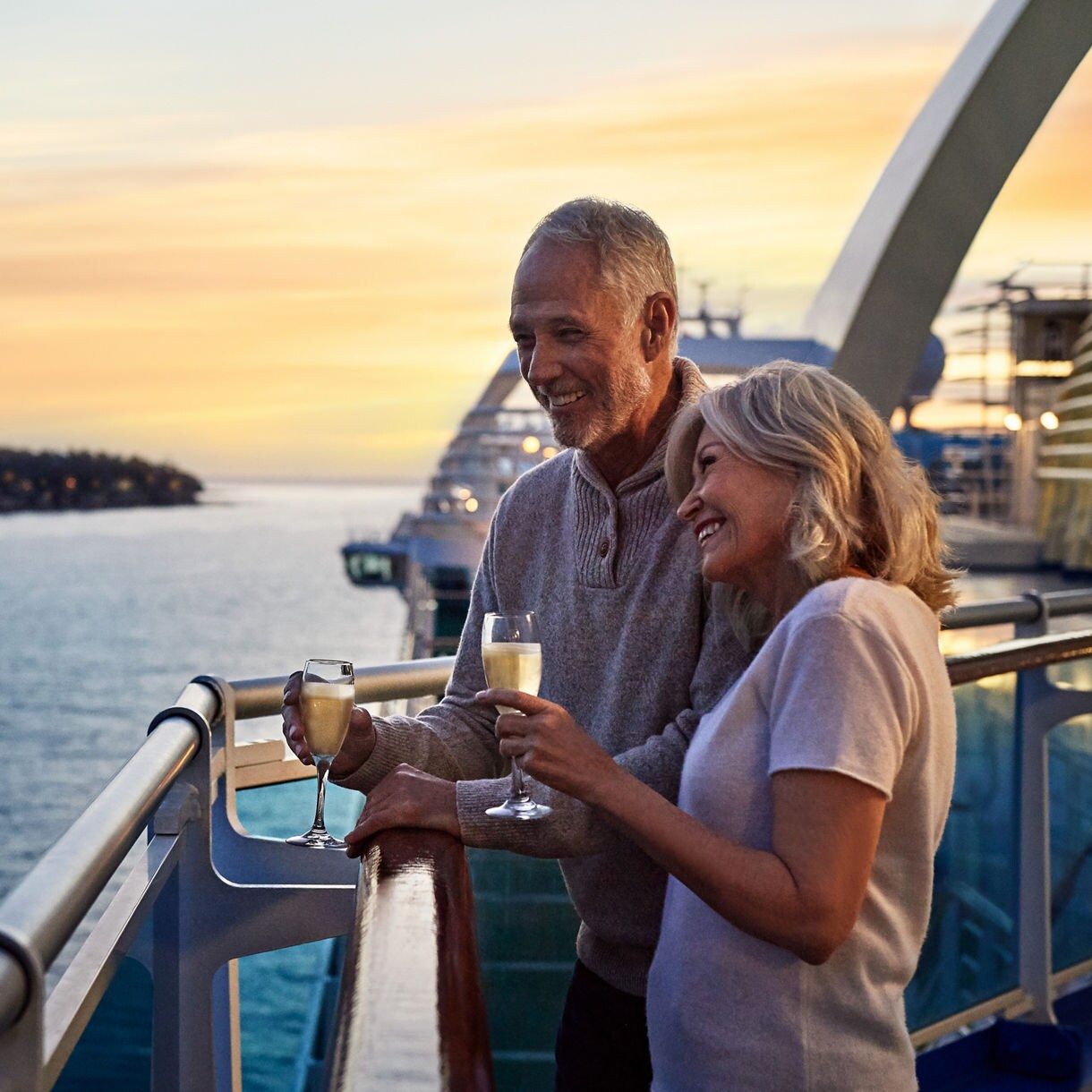 Couple enjoying sunset on cruise deck.