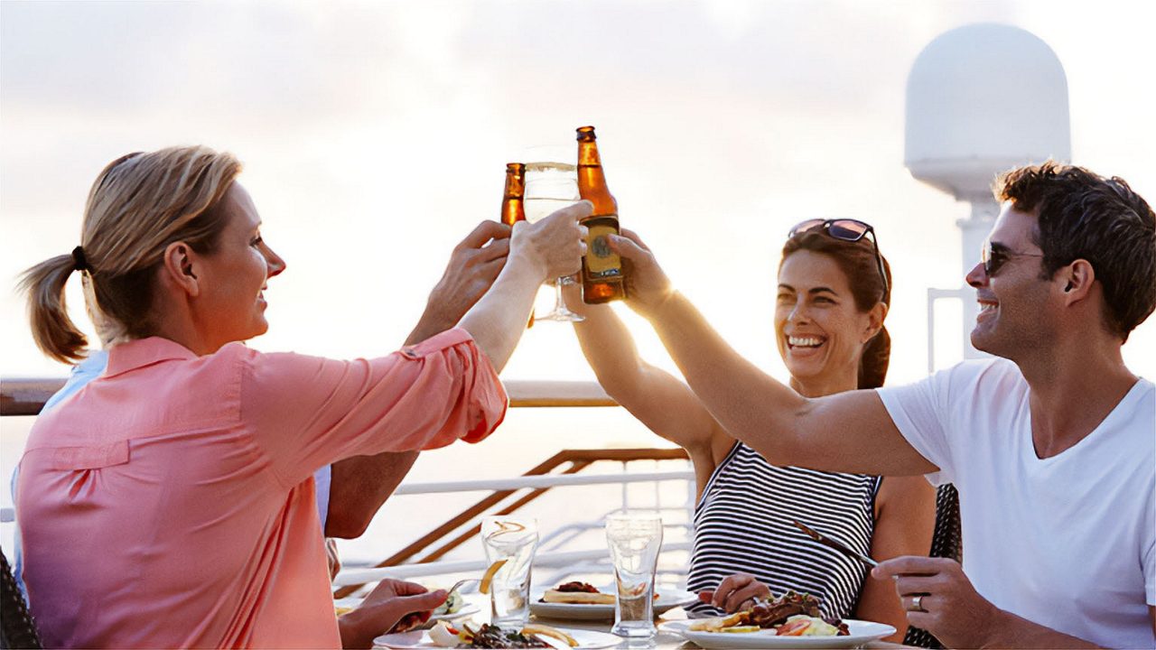 onboard dining outside celebration couples beer cheers