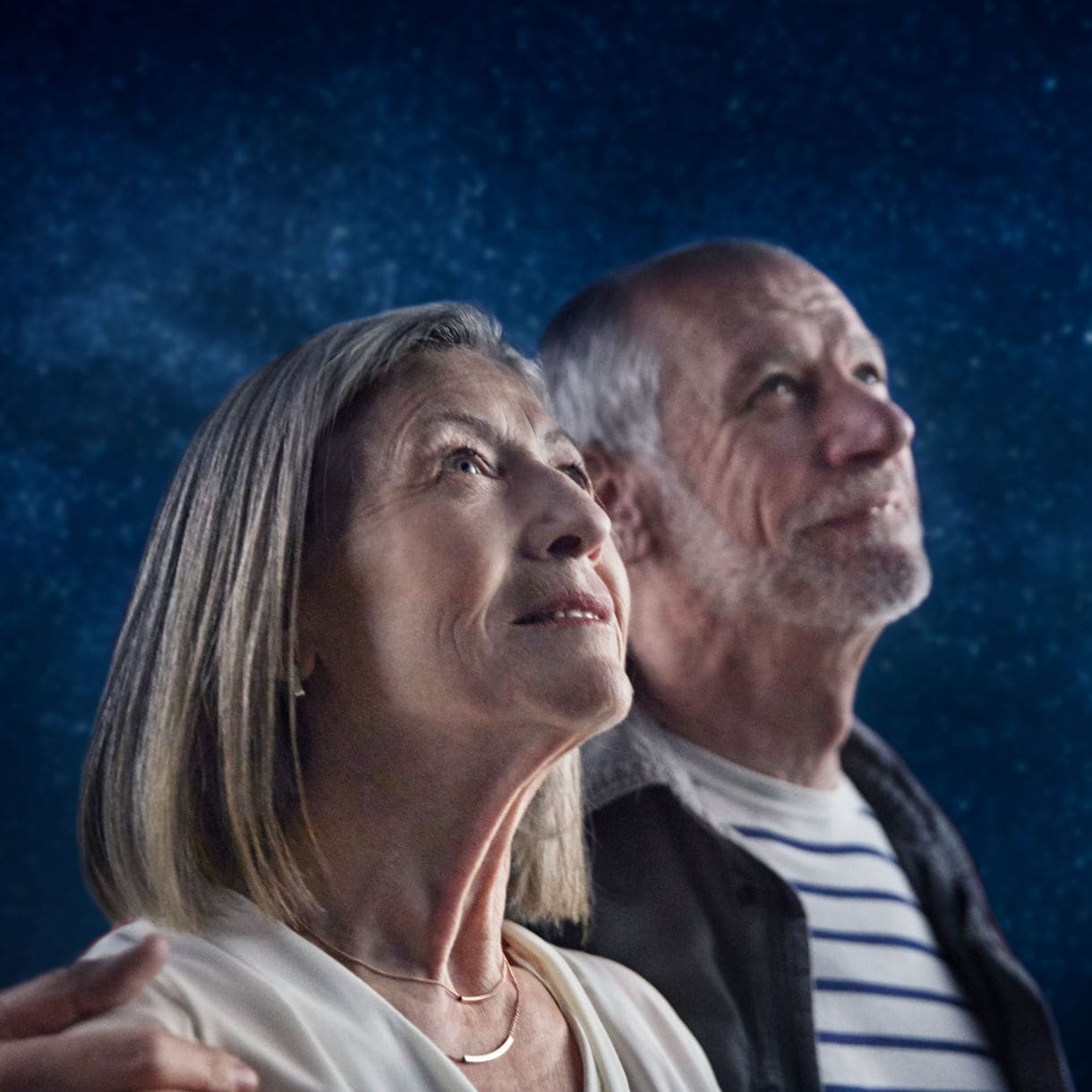 onboard older couple stargazing stars on deck