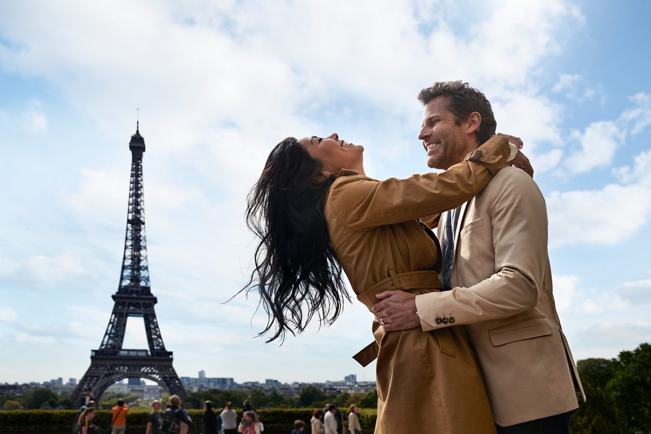 paris france eiffel tower couple embrace daytime