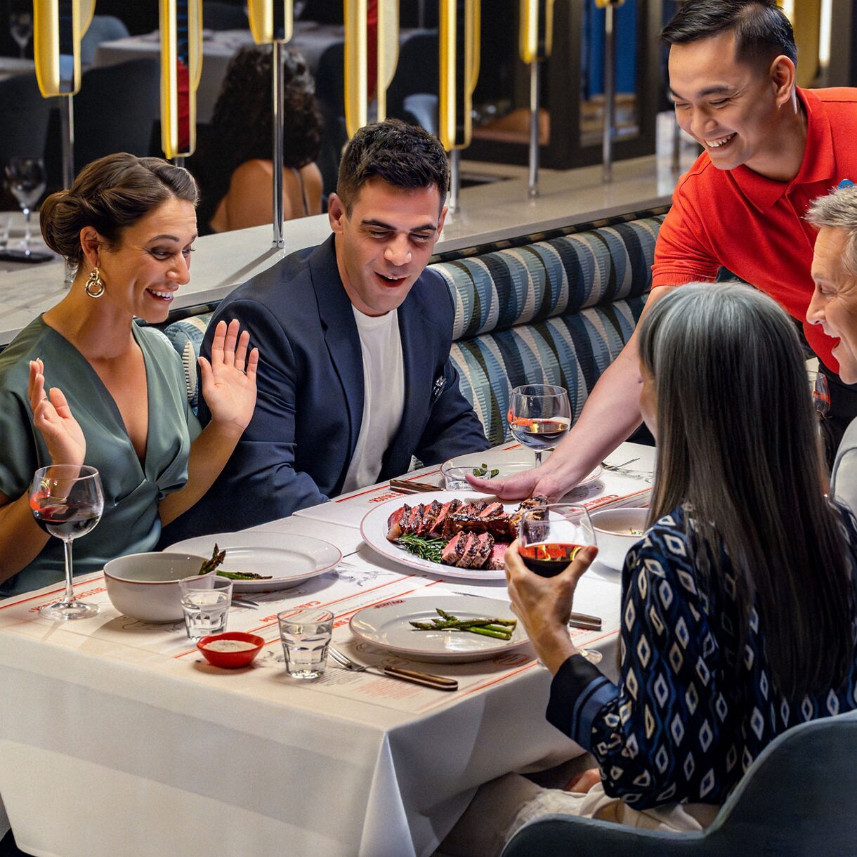 Couple  at a stateroom on the bed laughing  and having breakfast