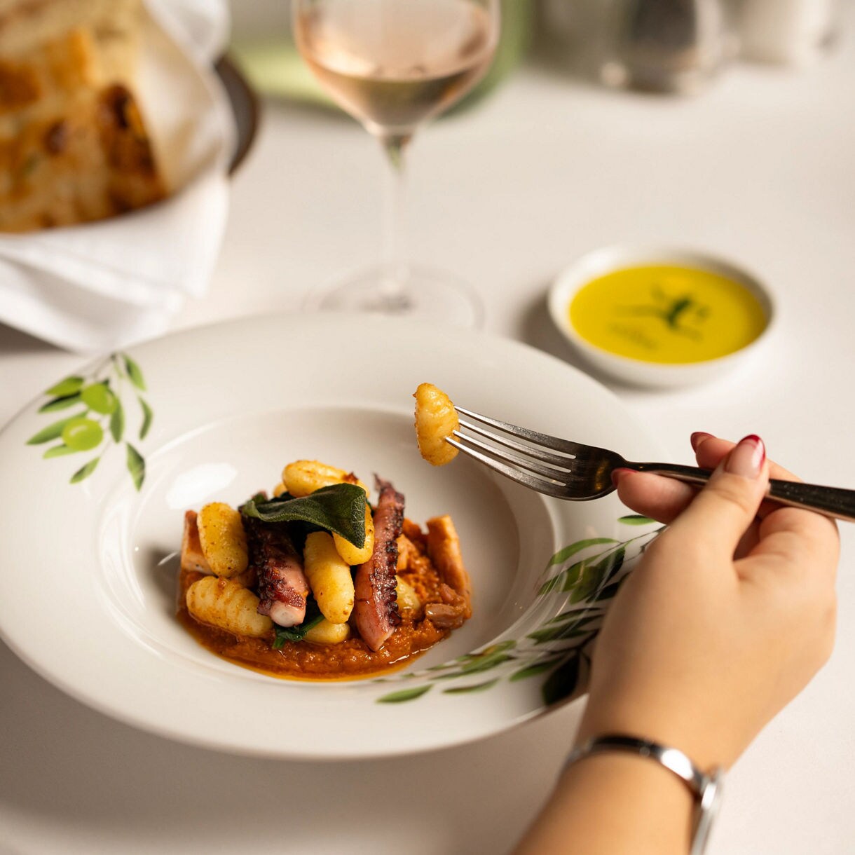Savor the elegance of the Grand Tuscan Dinner with this Polpo Grigliato con Pesto Rosso e Gnocchi di Spinaci.