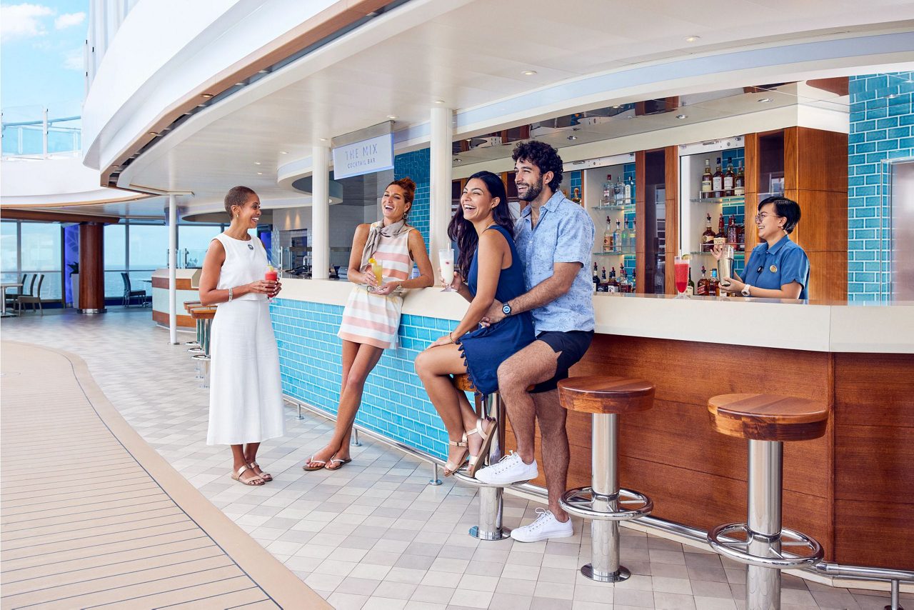 Modern poolside bar with vibrant lighting and contemporary design on the Lido Deck. 