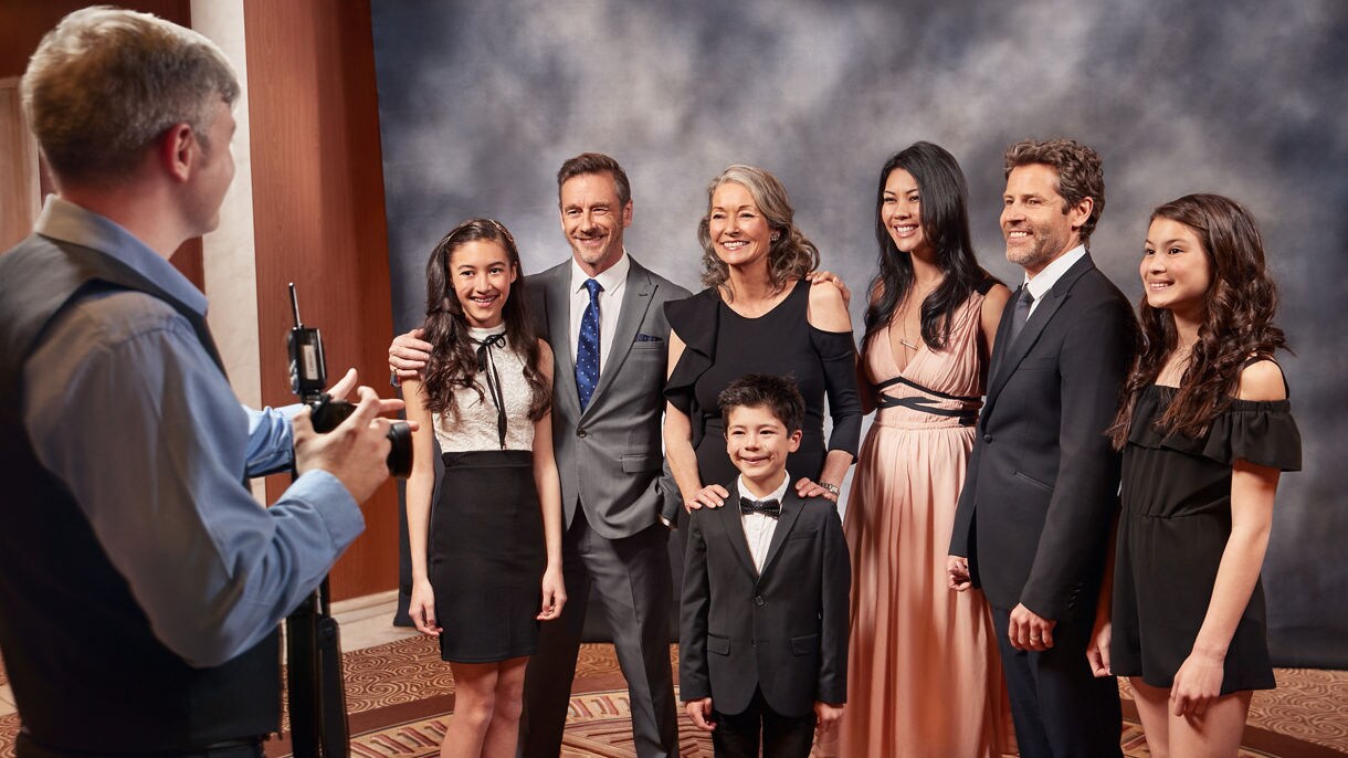 Portrait family photographer camera dressed formal backdrop