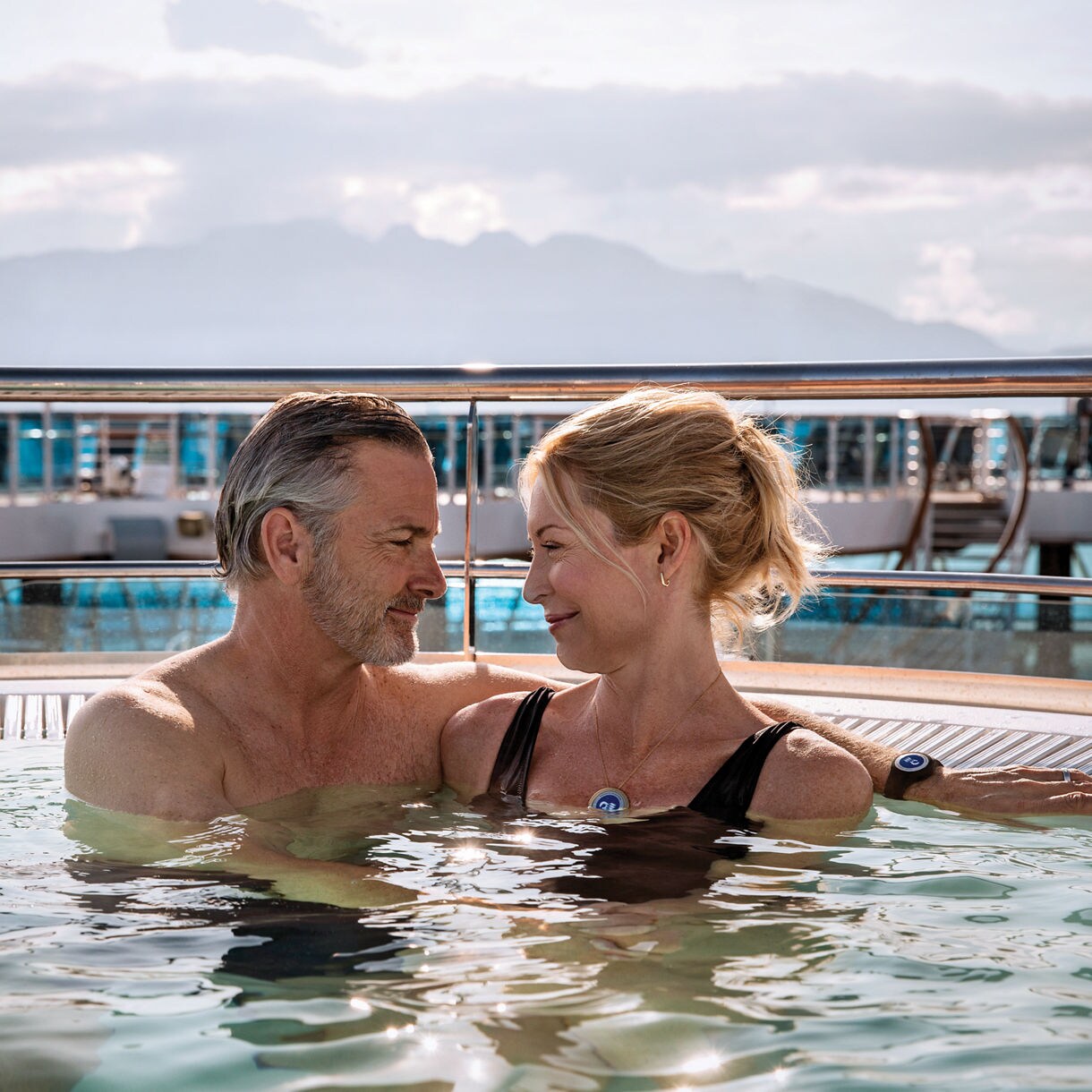 Guests of Enchanted Princess with Medallion drinks by the pool.