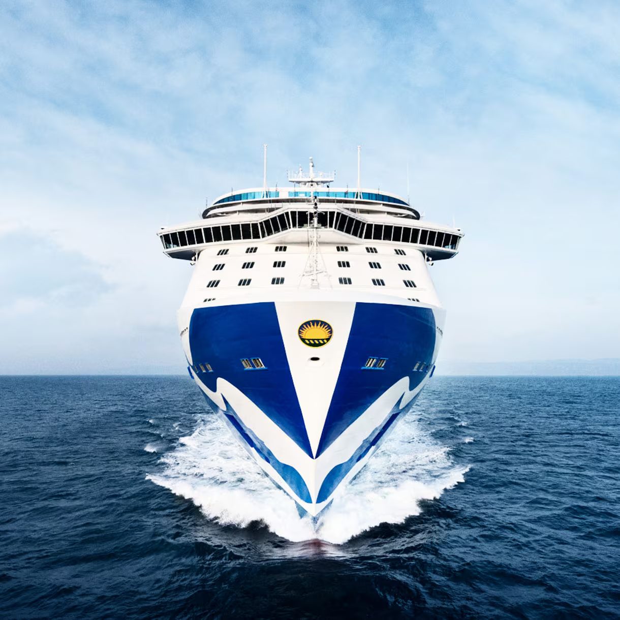 Front-facing view of a Princess® cruise ship sailing through calm ocean waters.