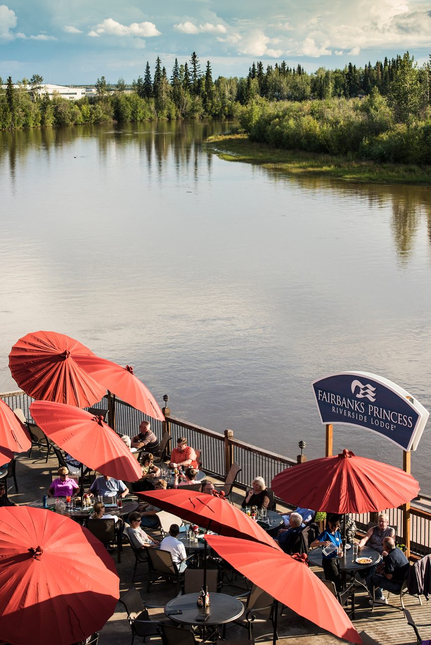 Riverside deck dining with stunning views of the Chena River at the Fairbanks Princess Riverside Lodge.