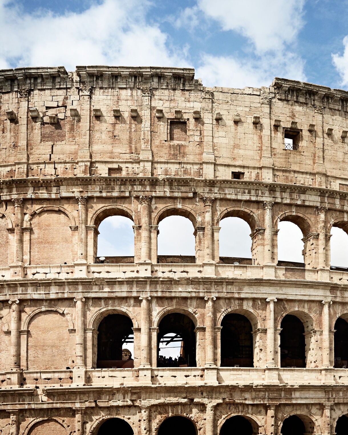 Historic Colosseum in Rome under blue sky