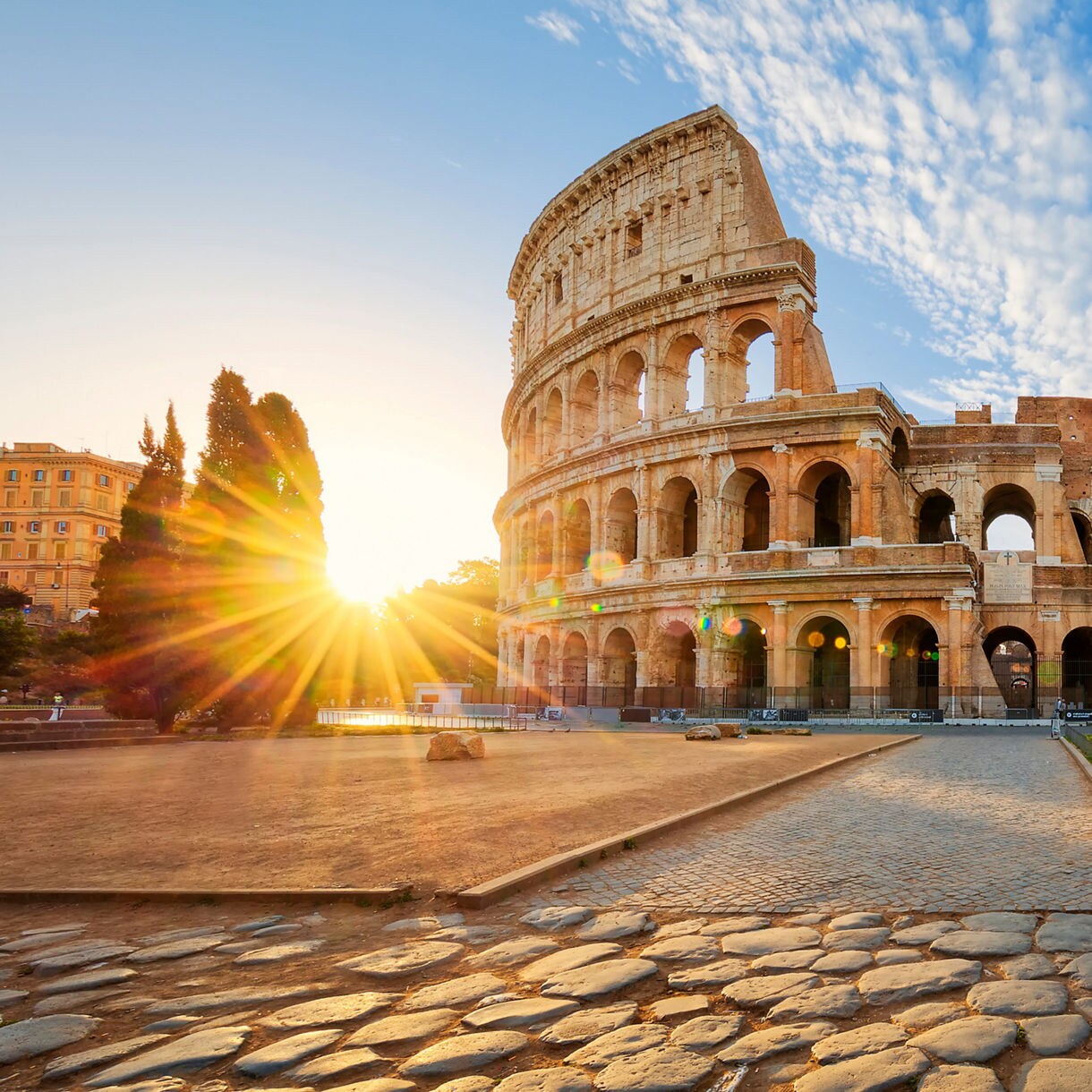 The Colosseum in Rome, Italy, with a stunning sunburst effect.