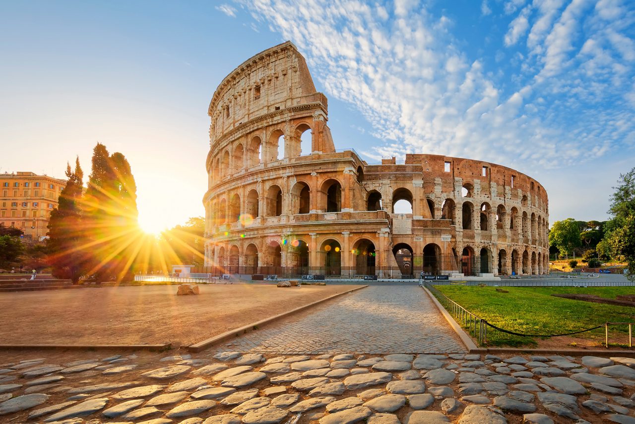 The Colosseum in Rome, Italy, with a stunning sunburst effect.