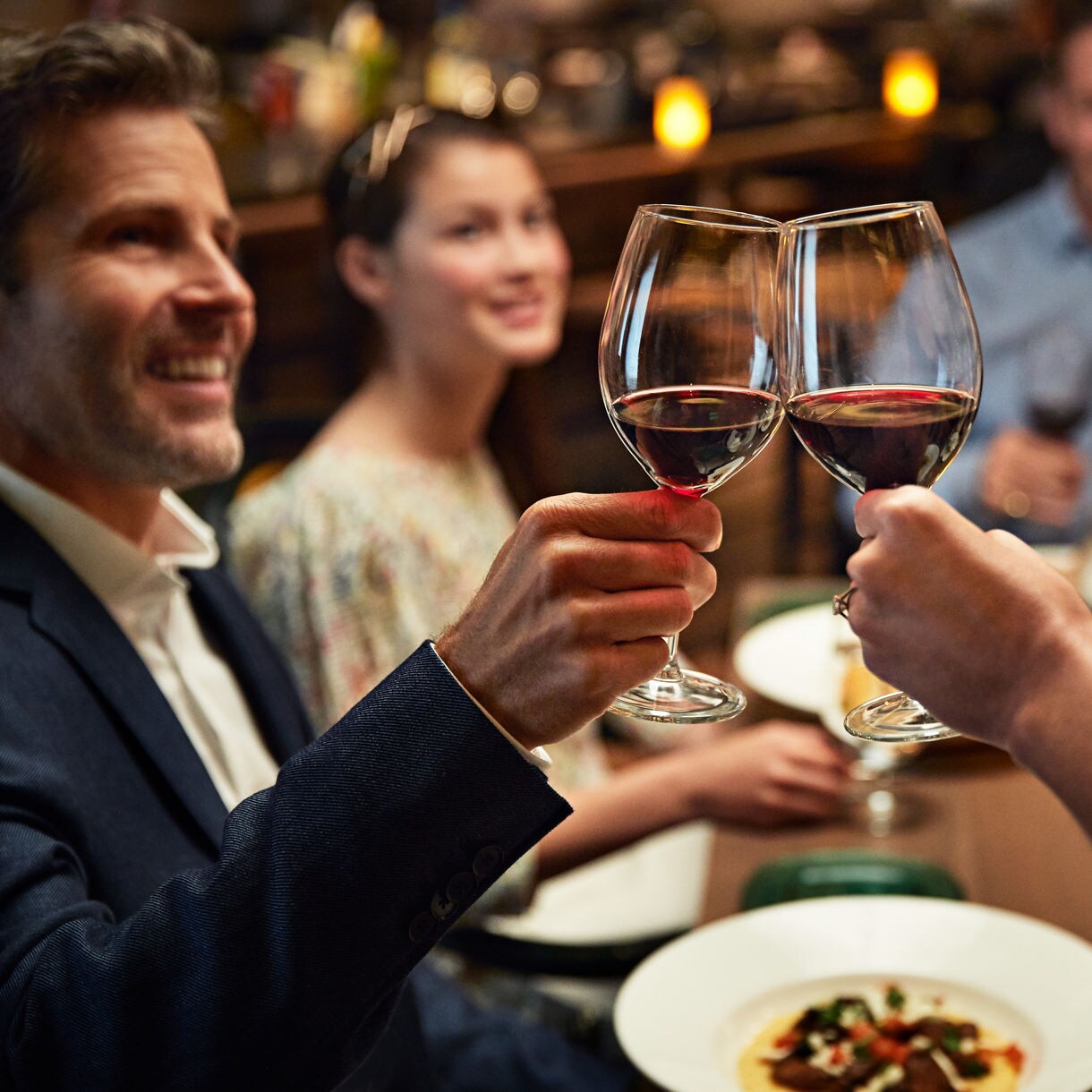 Friends toasting with red wine.