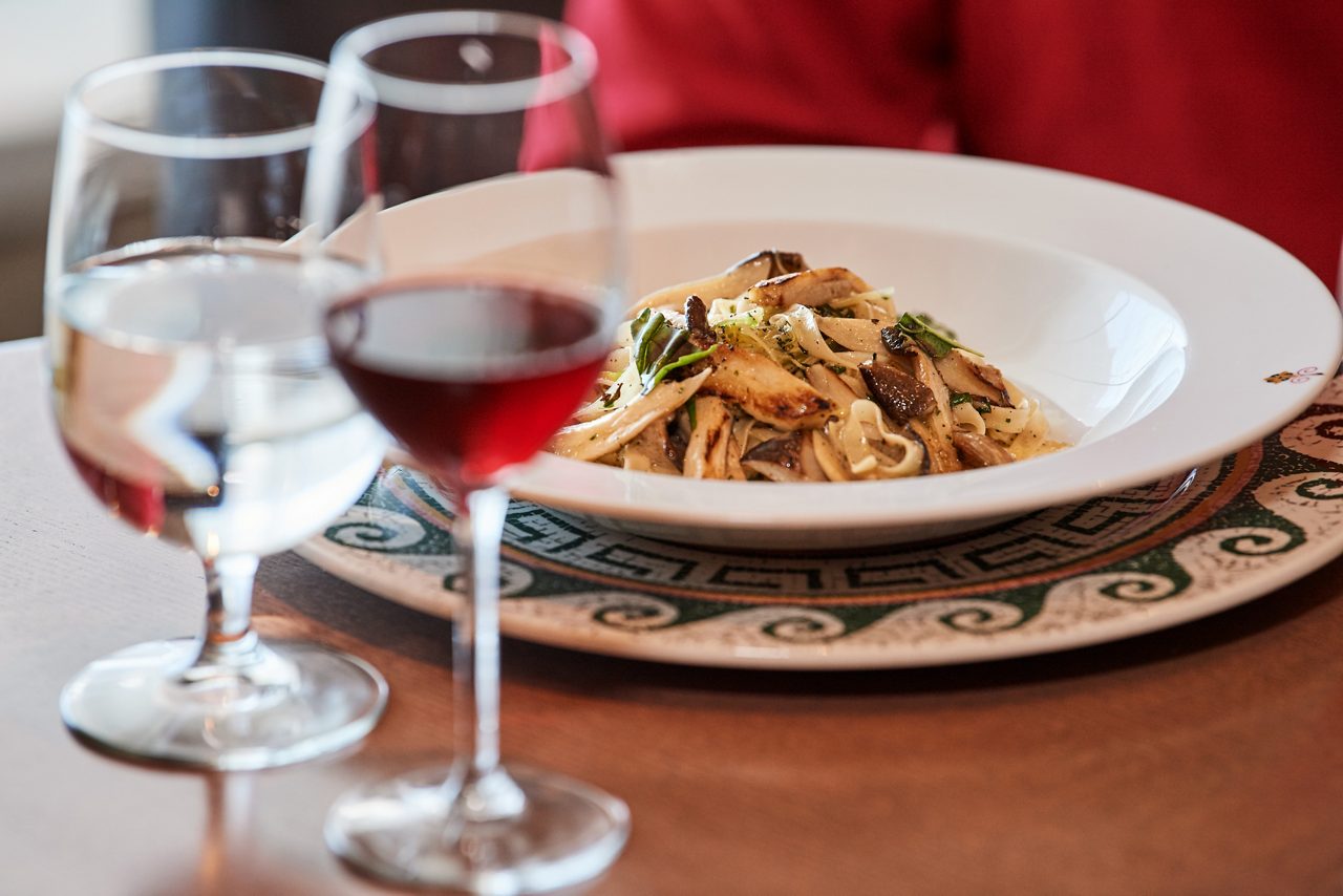 pasta dish and cup of wine