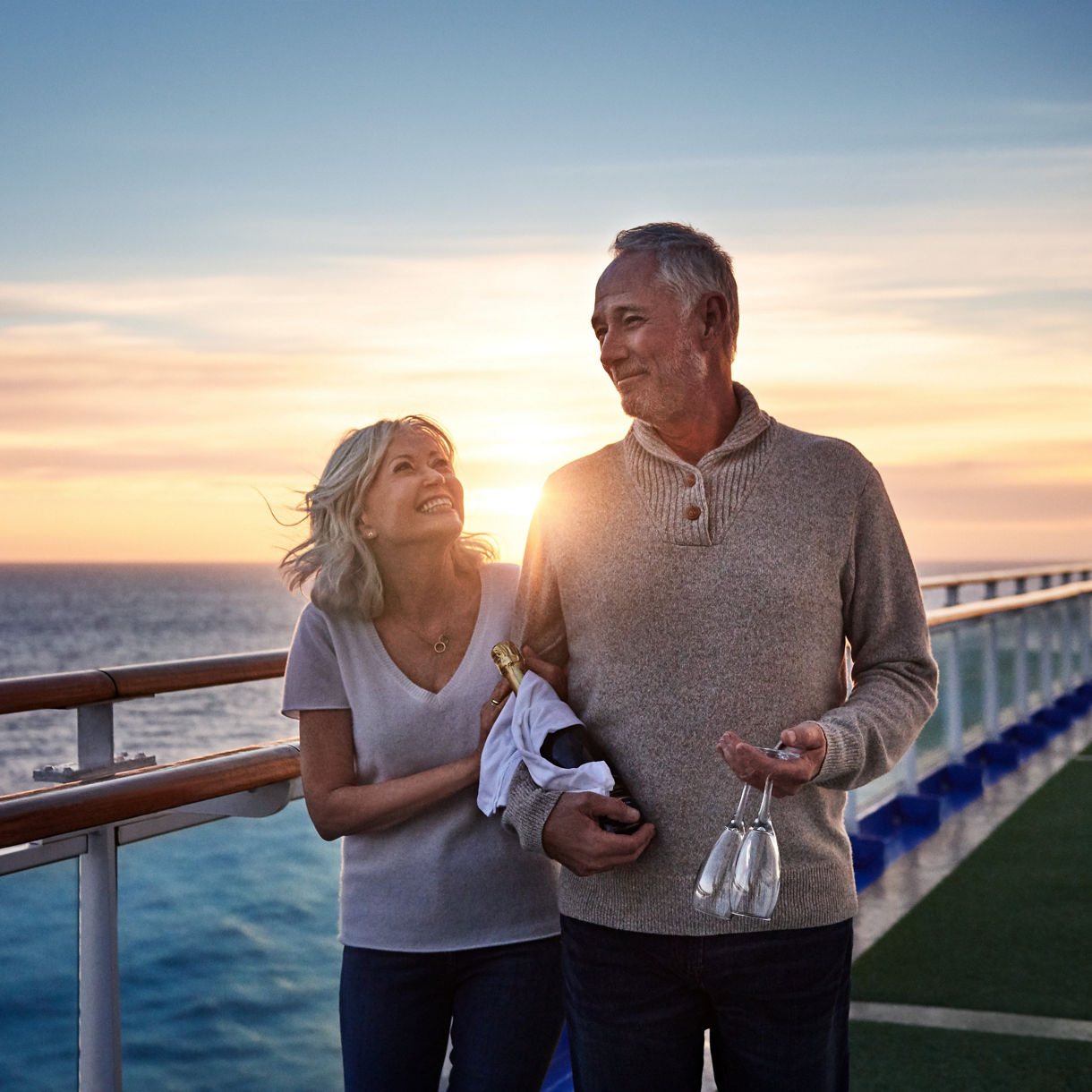 Couple enjoying sunset on cruise deck.