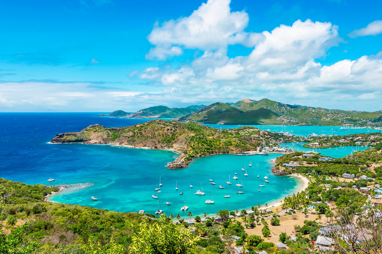 Panoramic view of Shirley Heights with lush green hills and sparkling ocean in Antigua and Barbuda.