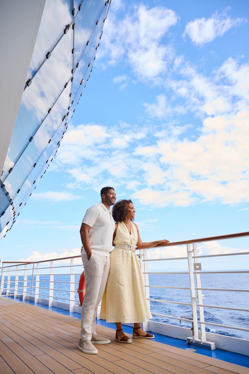 couple standing on the deck under the sphere