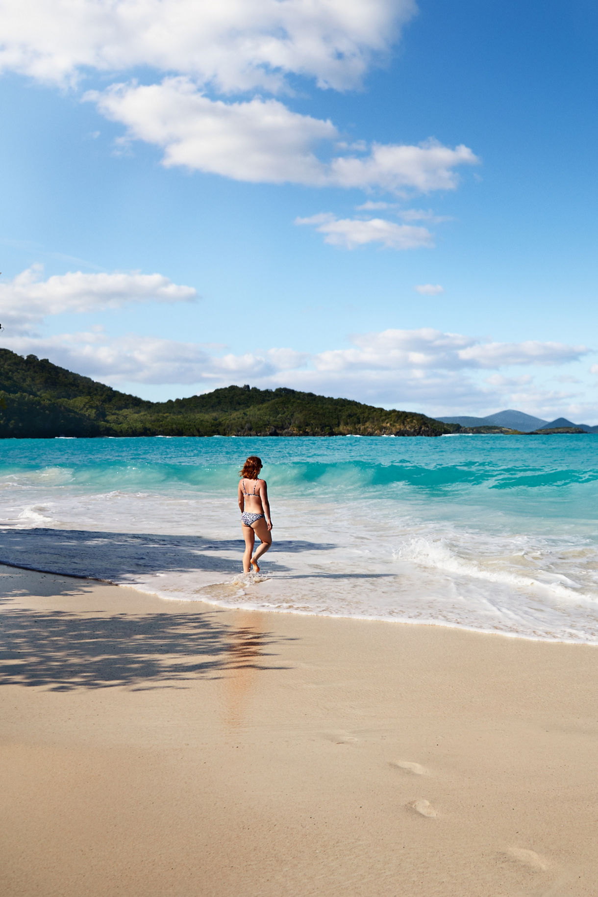 st john caribbean woman walking in surf