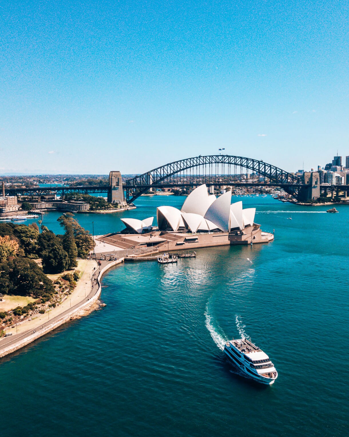 Landscape aerial view of Sydney Opera house near Sydney business center around the harbour.