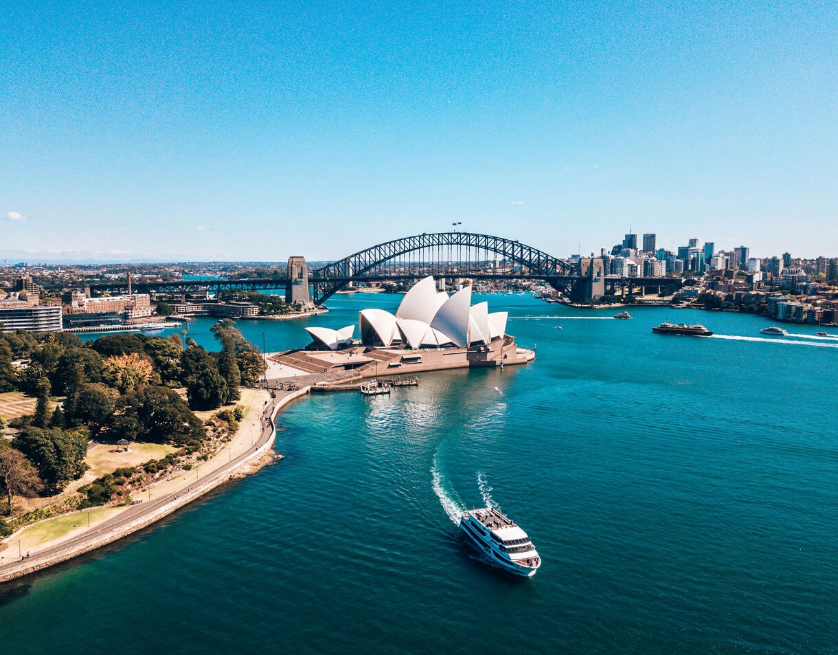 Landscape aerial view of Sydney Opera house near Sydney business center around the harbour.