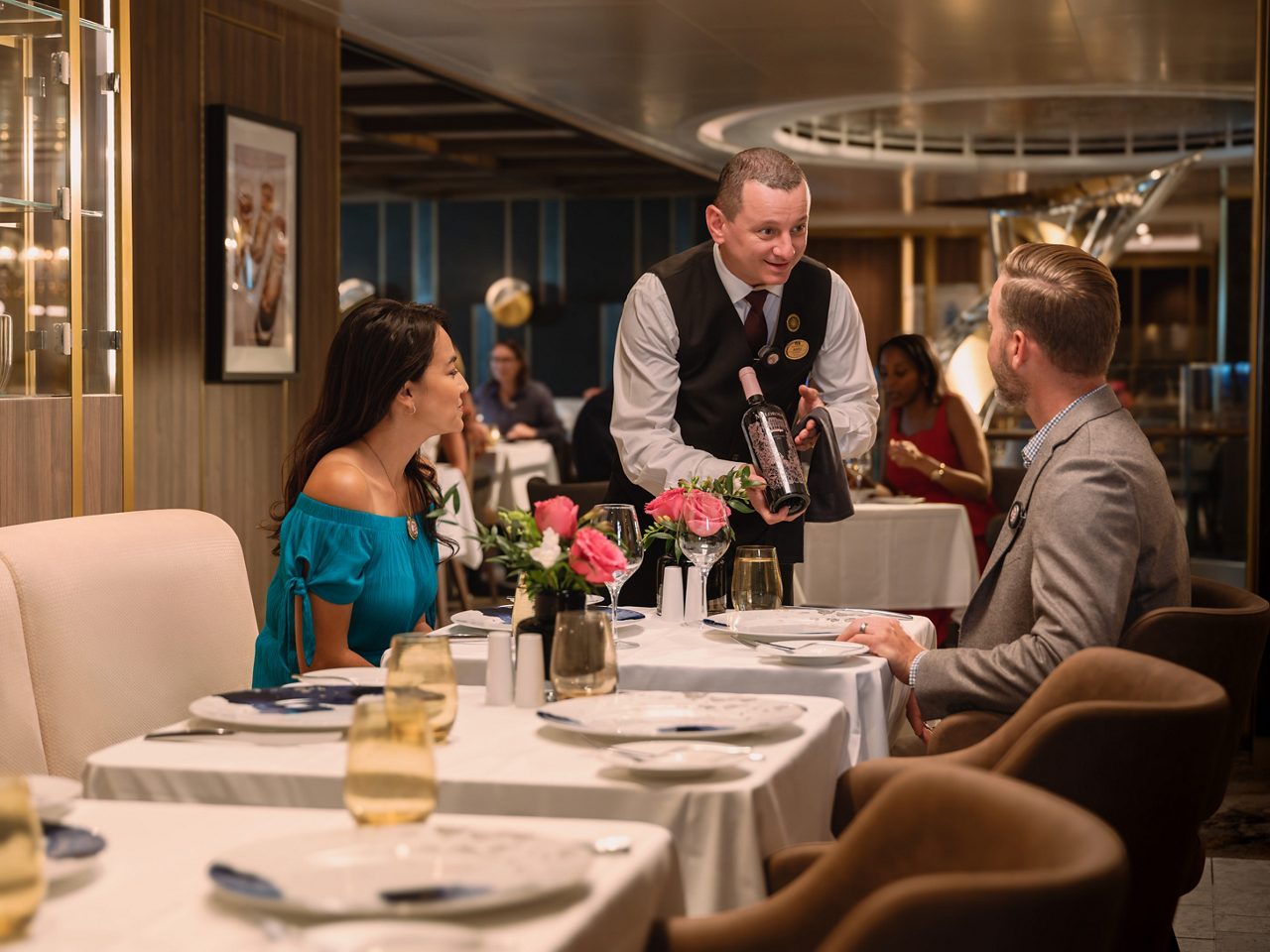 Waiter offering wine to a couple