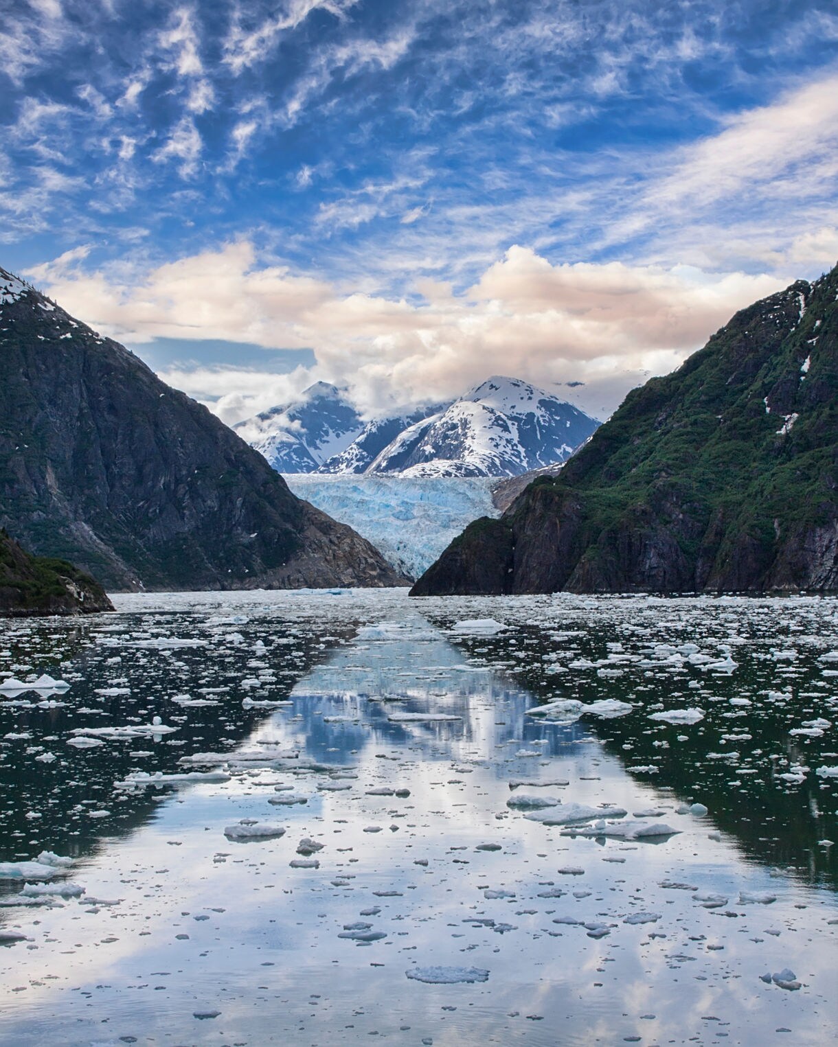 View of South Sawyer Glacier in the distance, surrounded by steep, snow-dusted cliffs.