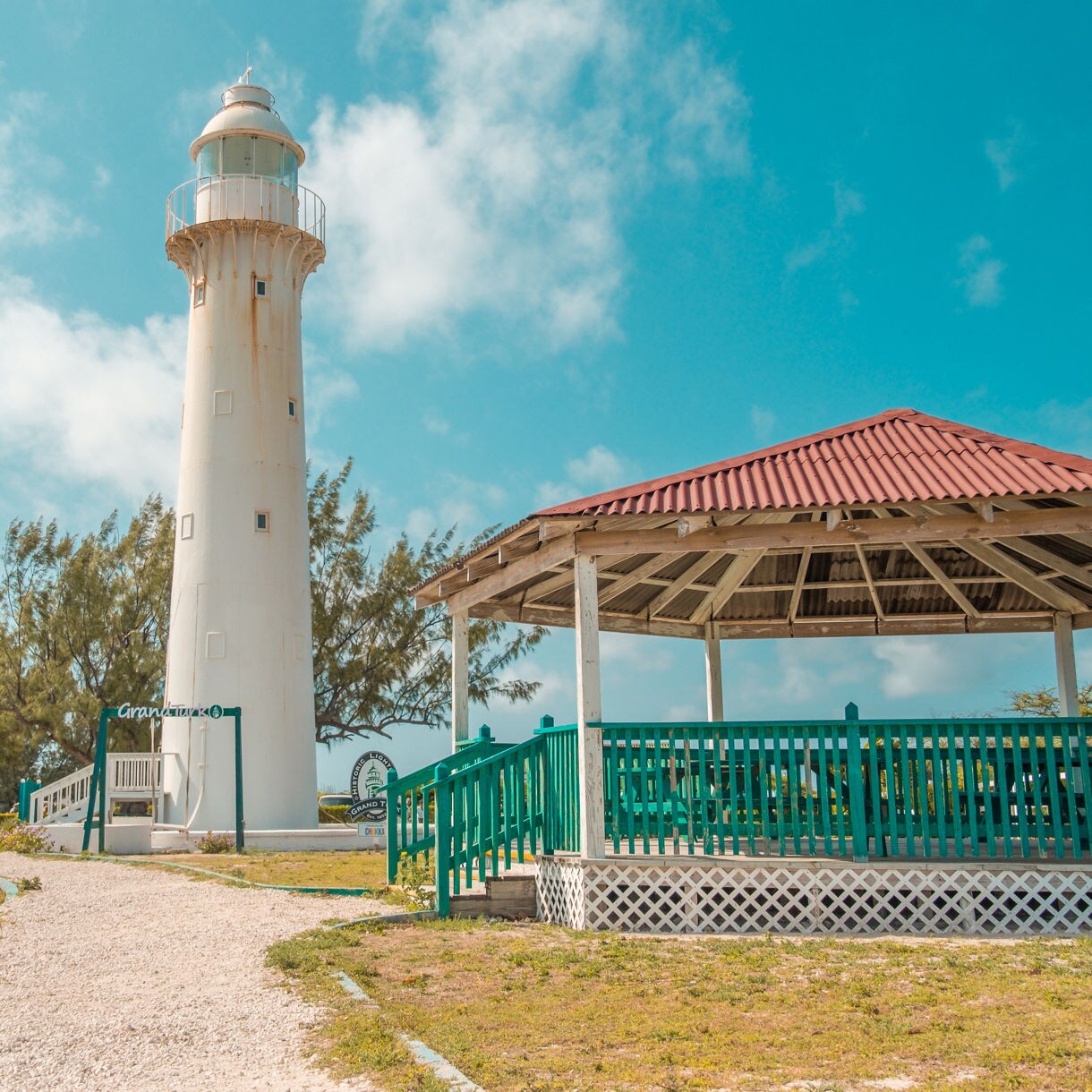 The Grand Turk Lighthouse towering over the island, with a nearby gazebo and 
