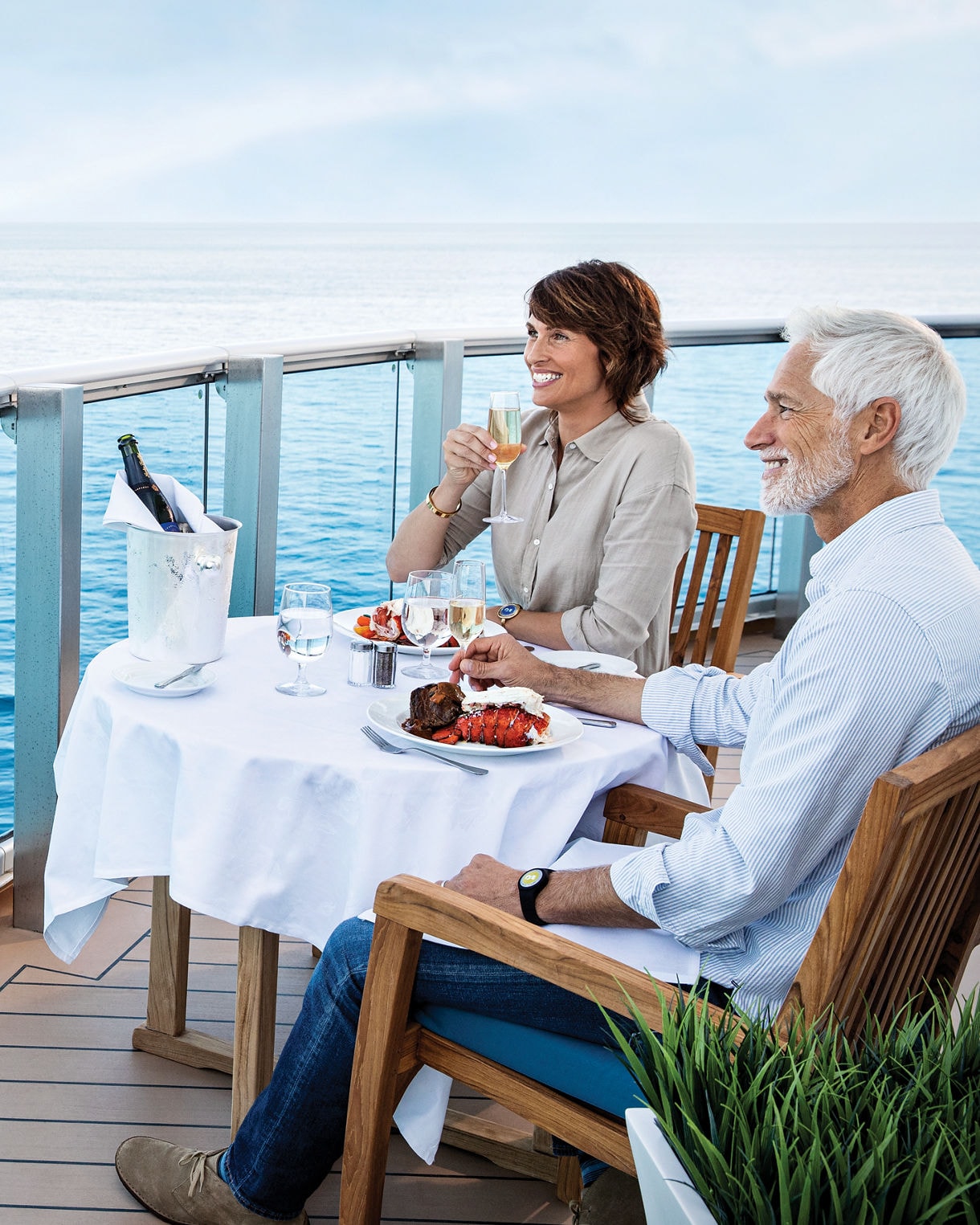 Couple enjoying a drink on the deck of a ship