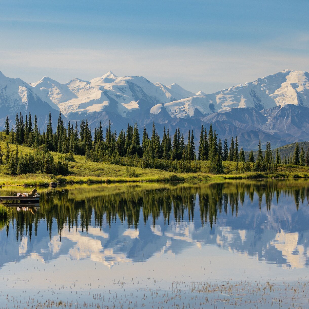 Snow-capped mountains reflected in calm lake landscape